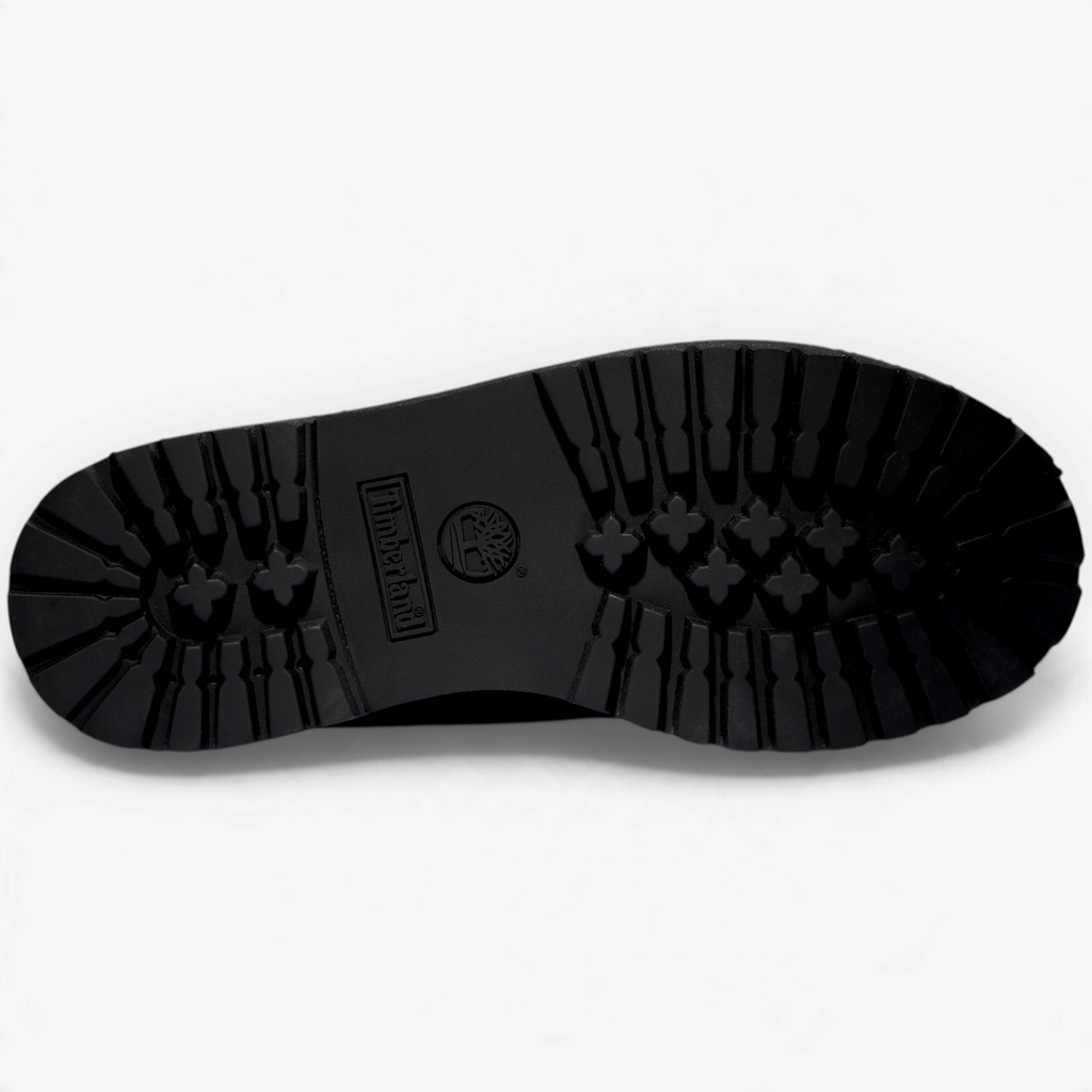 METRO Timberland kids' black waterproof boot showing the rugged rubber lug sole tread pattern from below