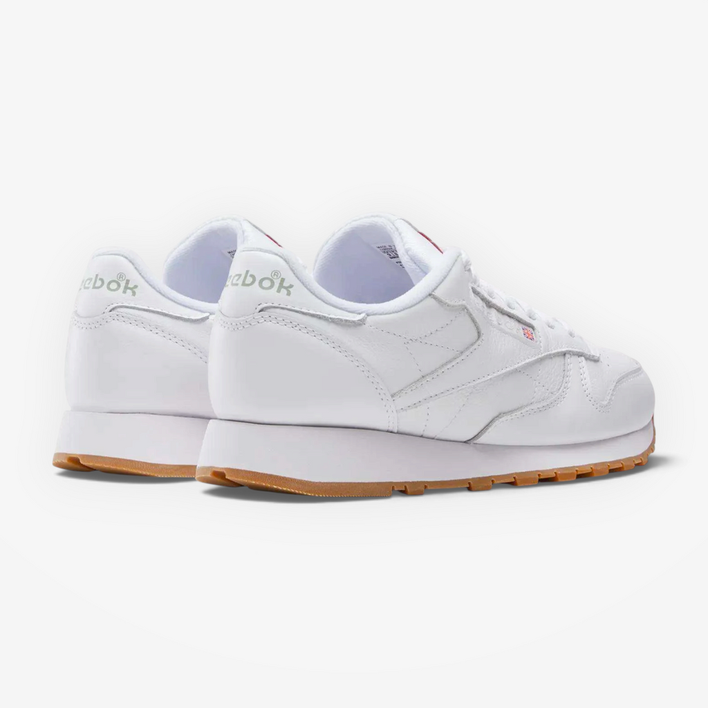 METRO Reebok Classic Leather sneakers in white leather with grey accents and a gum rubber outsole, rear view.