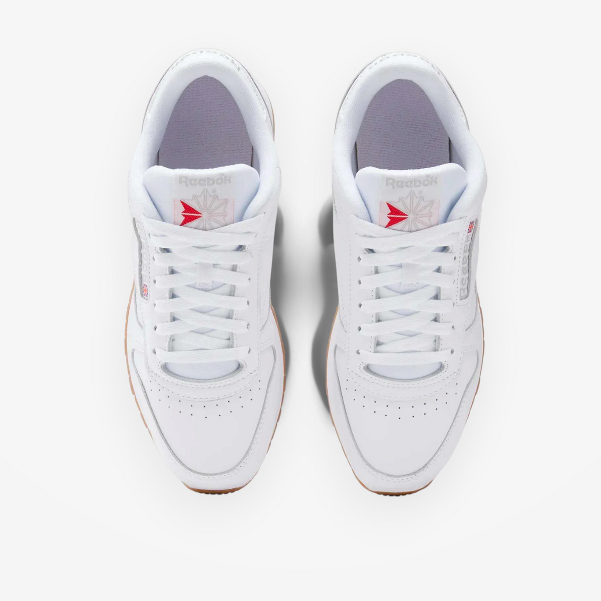 METRO Reebok Classic Leather sneakers in white with grey accents and gum soles, top-down view.