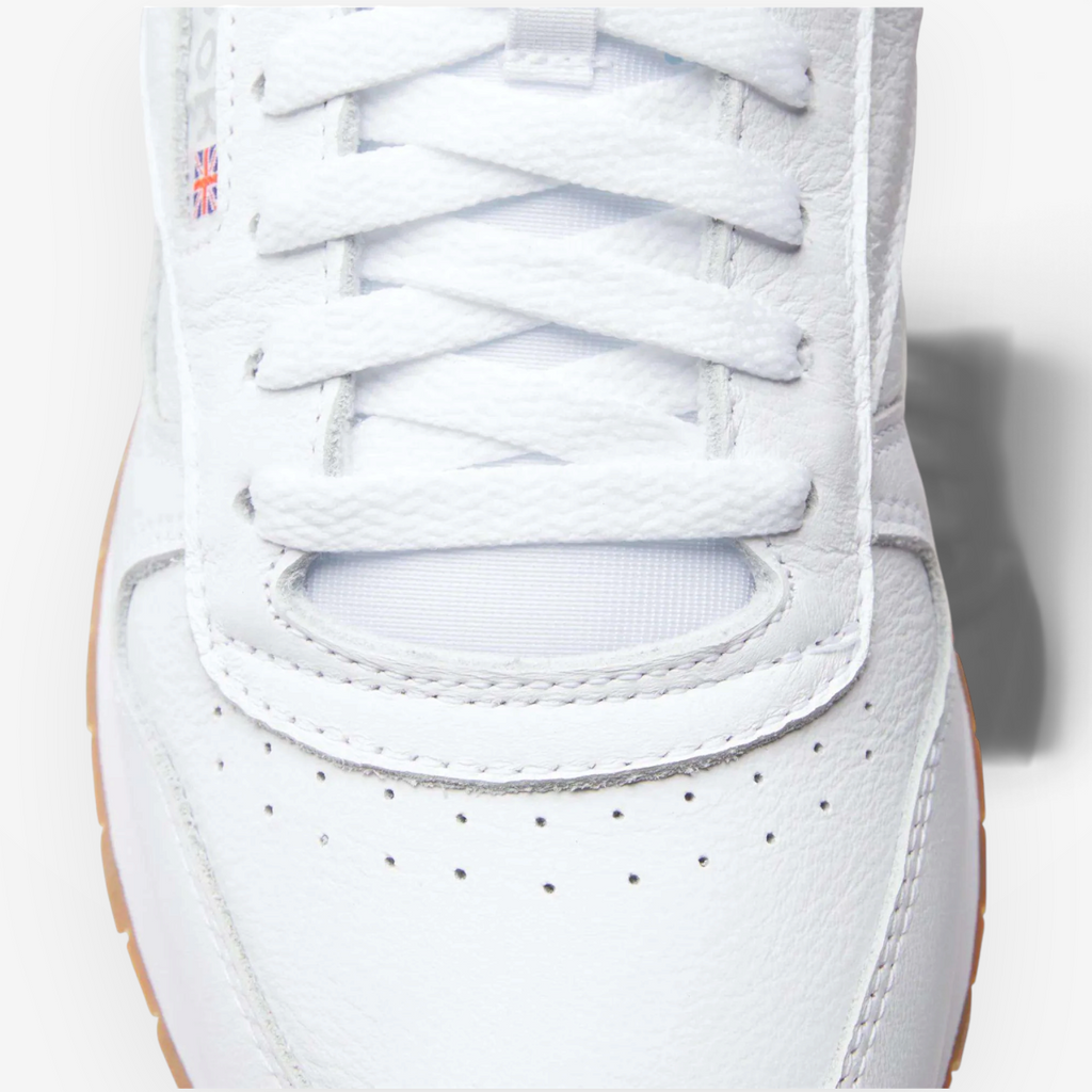 METRO Reebok Classic Leather sneaker in white leather with grey accents and a gum sole, featuring a Union Jack logo.