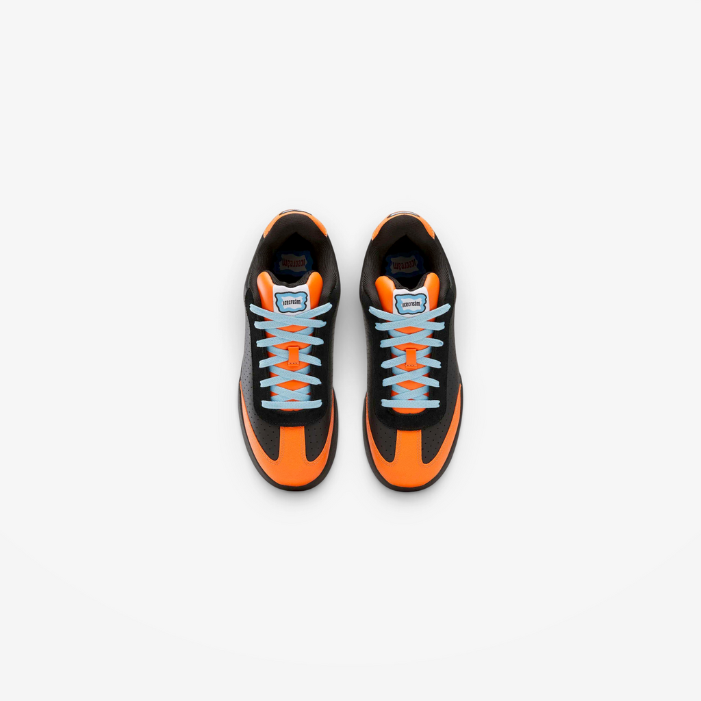 METRO Reebok x ICECREAM Board Flip sneakers in black, orange, and blue suede with a low-cut skate-inspired design.