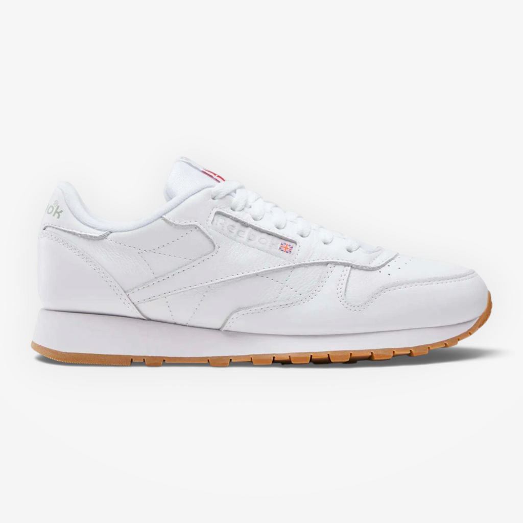 METRO Reebok Classic Leather sneakers in white leather with grey accents and a gum rubber outsole, side profile view.