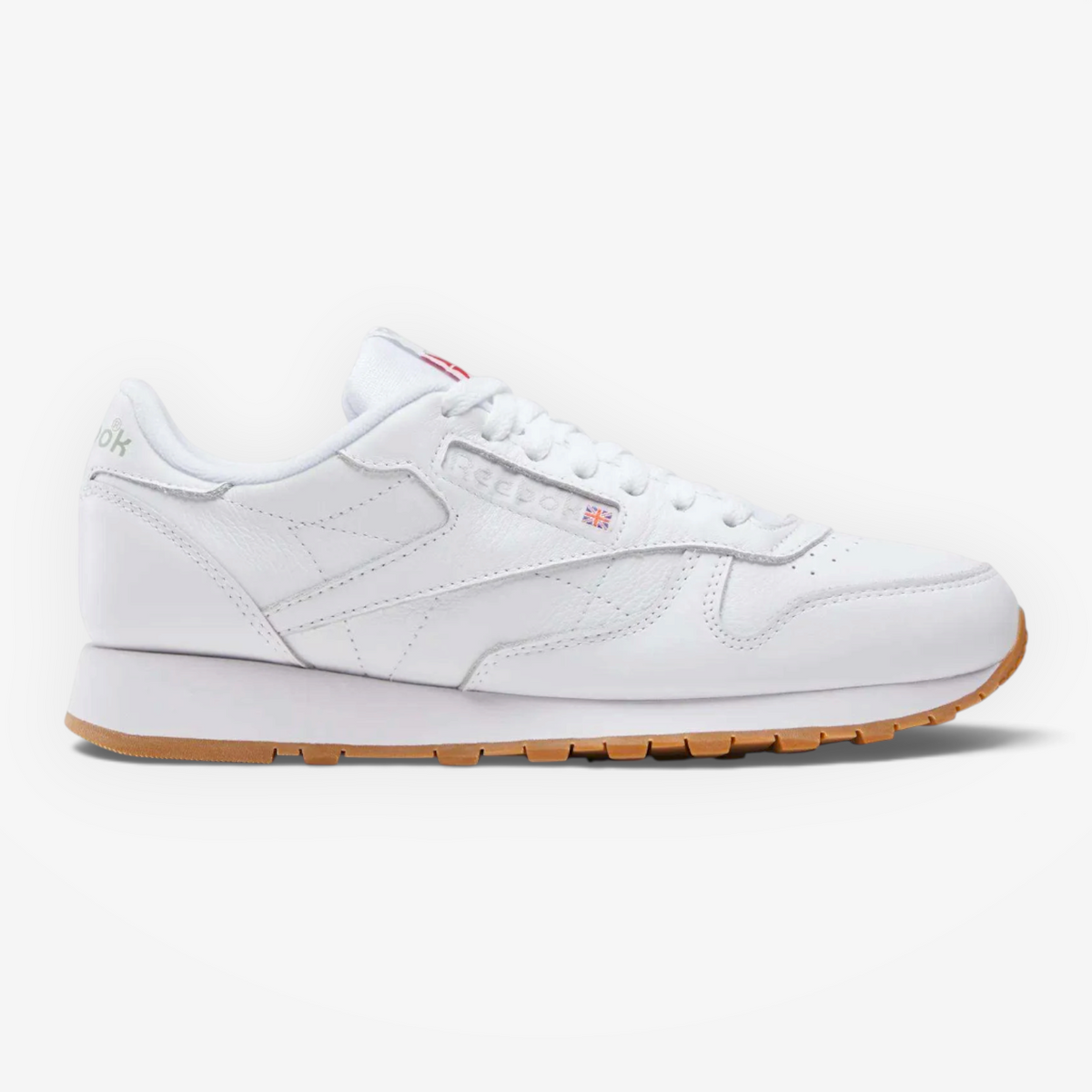 METRO Reebok Classic Leather sneakers in white leather with grey accents and a gum rubber outsole, side profile view.