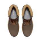 Brown leather boots with orange laces on a white background