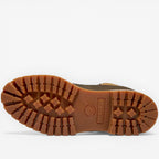 Close-up of a brown boot sole with brand logo on a white background