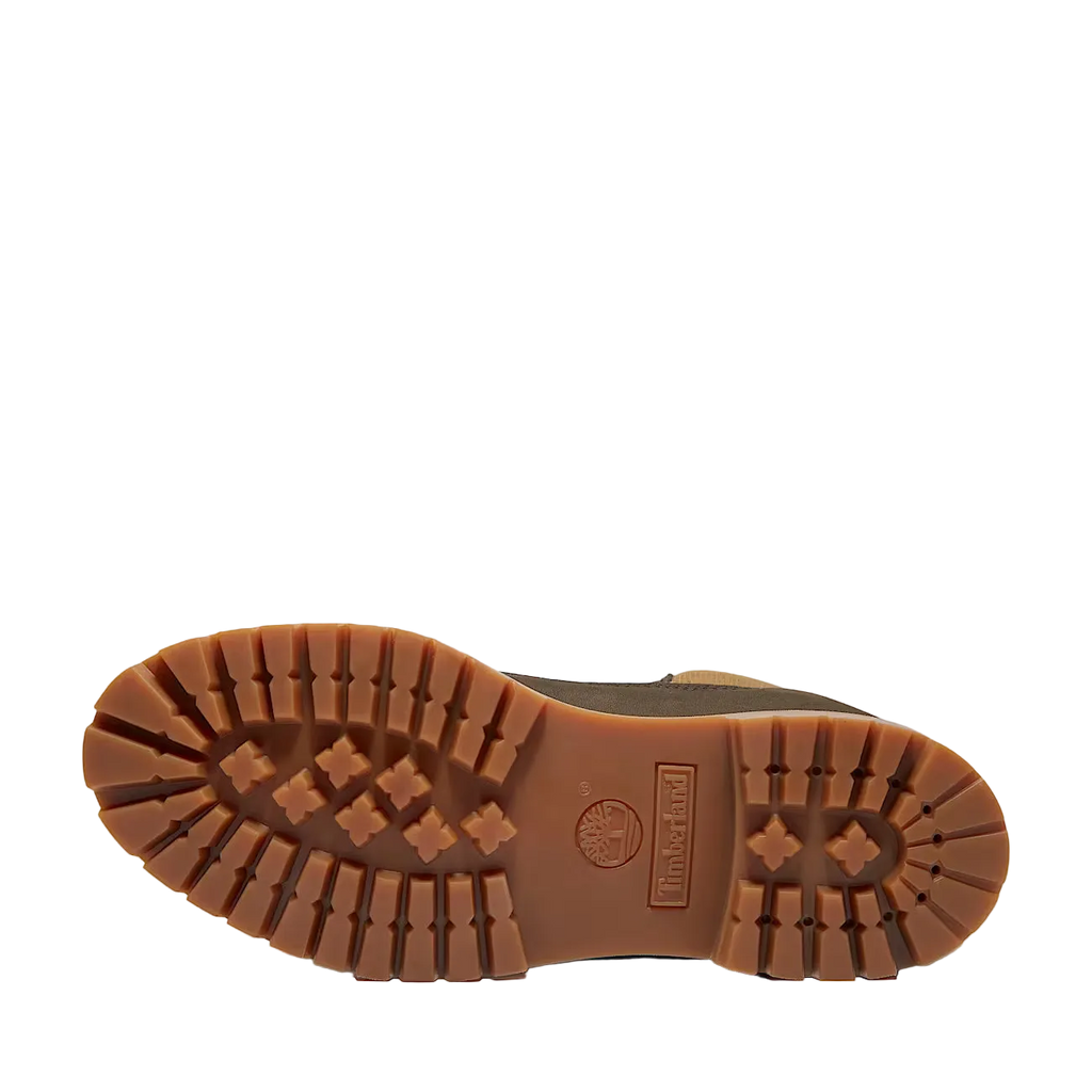 Close-up of a brown boot sole with brand logo on a white background