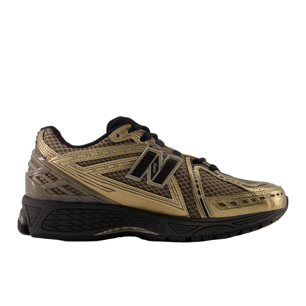 Gold and black New Balance sneaker with mesh upper and black sole, stylish footwear