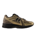 Gold and black New Balance sneaker with mesh upper and black sole, stylish footwear