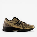 Gold and black New Balance sneaker with mesh upper and black sole, stylish footwear