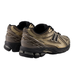 New Balance sneakers in metallic gold and black, stylish footwear for sneaker enthusiasts