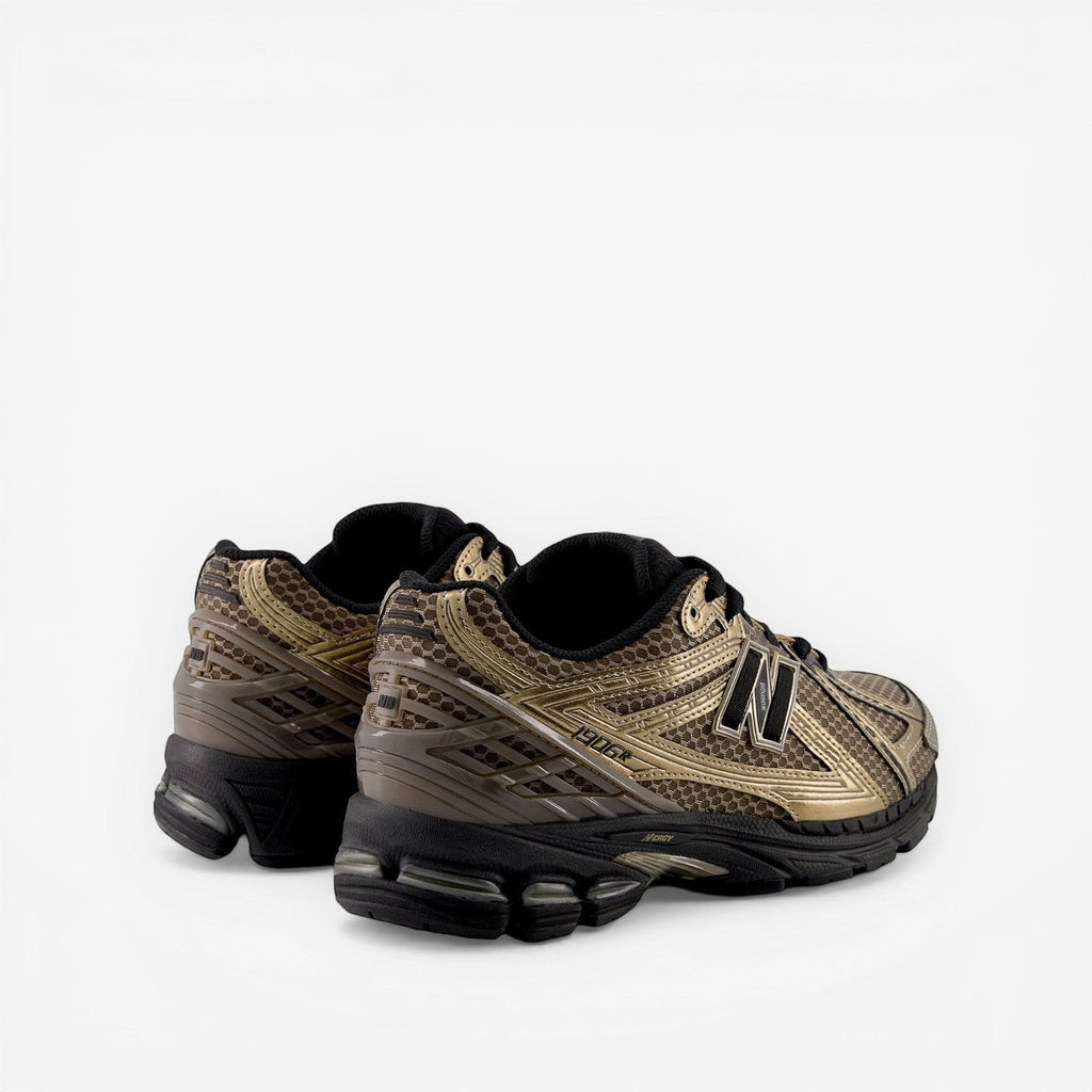 New Balance sneakers in metallic gold and black, stylish footwear for sneaker enthusiasts