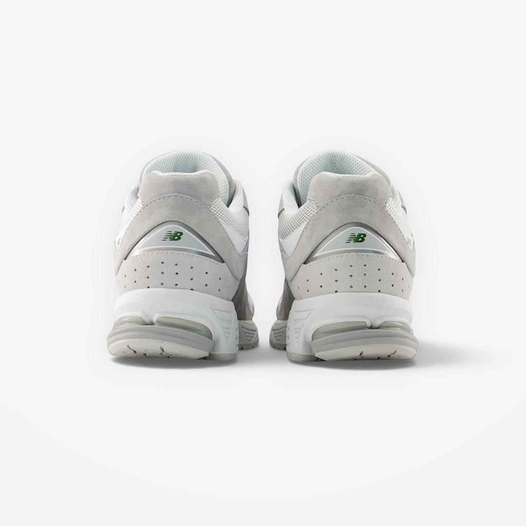 Back view of New Balance grey sneakers, premium suede and mesh footwear for men