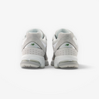 Back view of New Balance grey sneakers, premium suede and mesh footwear for men