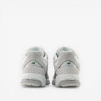 Back view of New Balance grey sneakers, premium suede and mesh footwear for men