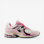 Pink and white New Balance sneaker with mesh and suede details, lifestyle footwear