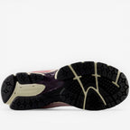 new balance sneaker outsole in black and beige with textured tread pattern, footwear detail
