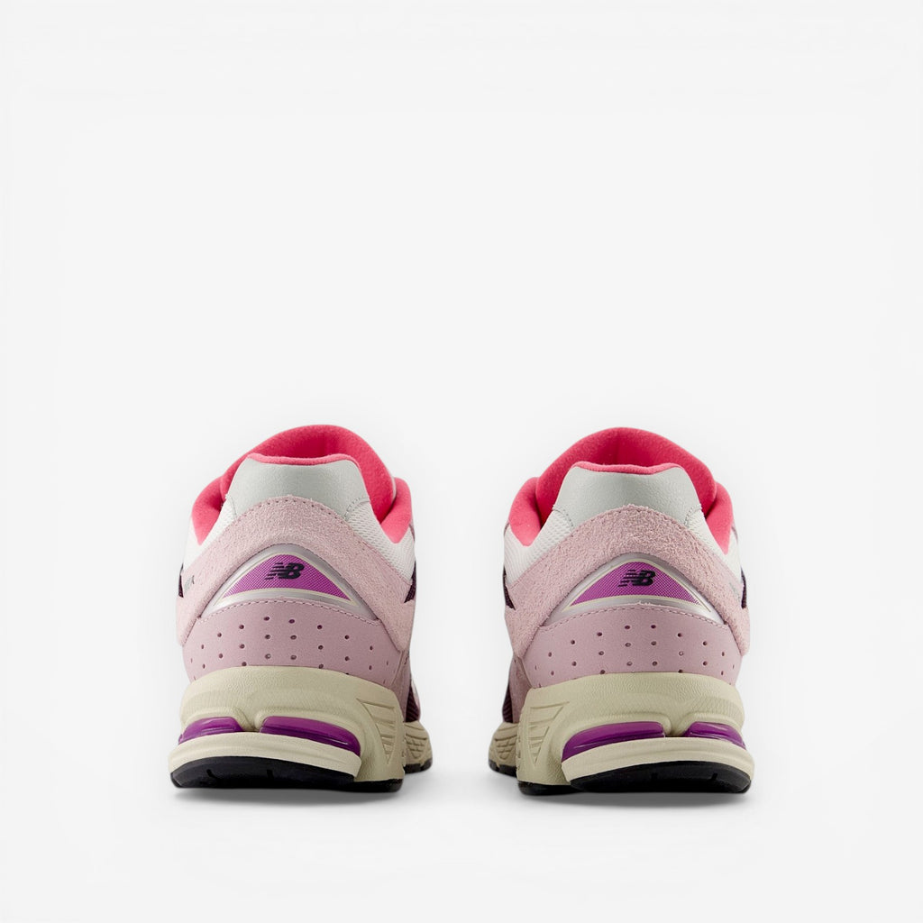 Pair of New Balance pink and purple sneakers, rear view, stylish footwear