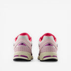 Pair of New Balance pink and purple sneakers, rear view, stylish footwear