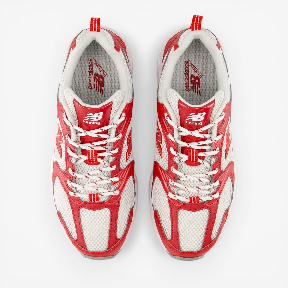 Pair of New Balance red and white running sneakers, mesh upper, white laces, top view