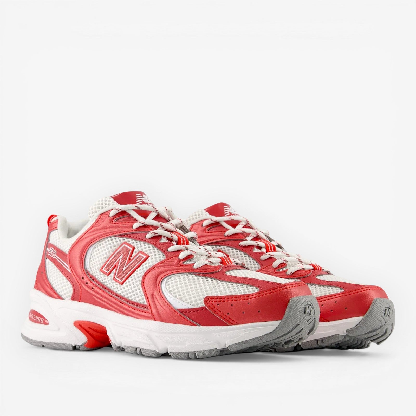 New Balance red and white sneakers with grey sole, athletic footwear