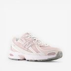 New Balance pink mesh sneaker with white accents, side profile, athletic footwear