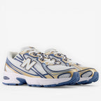 New Balance sneakers white mesh with blue and gold accents, athletic footwear