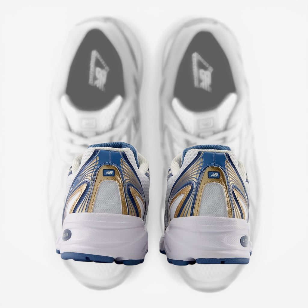 Back view of New Balance sneakers in white, blue, and gold colorway, athletic footwear