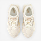 top view beige New Balance sneakers with mesh and suede details, laced, on black background