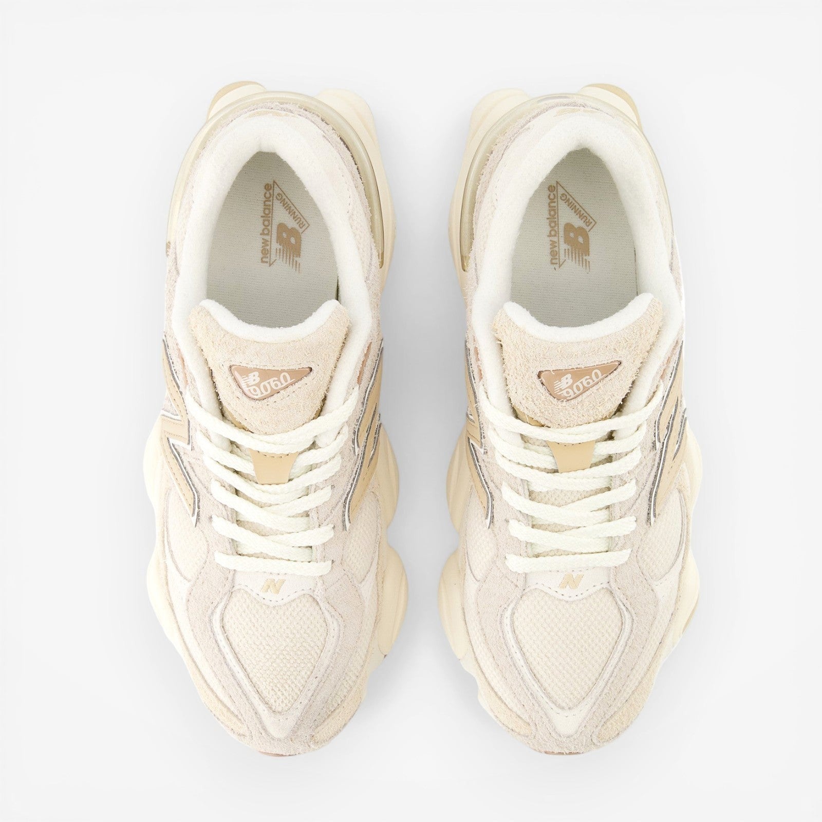 top view beige New Balance sneakers with mesh and suede details, laced, on black background