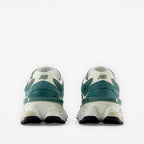 Back view of green and white New Balance sneakers with chunky sole, footwear sneakers