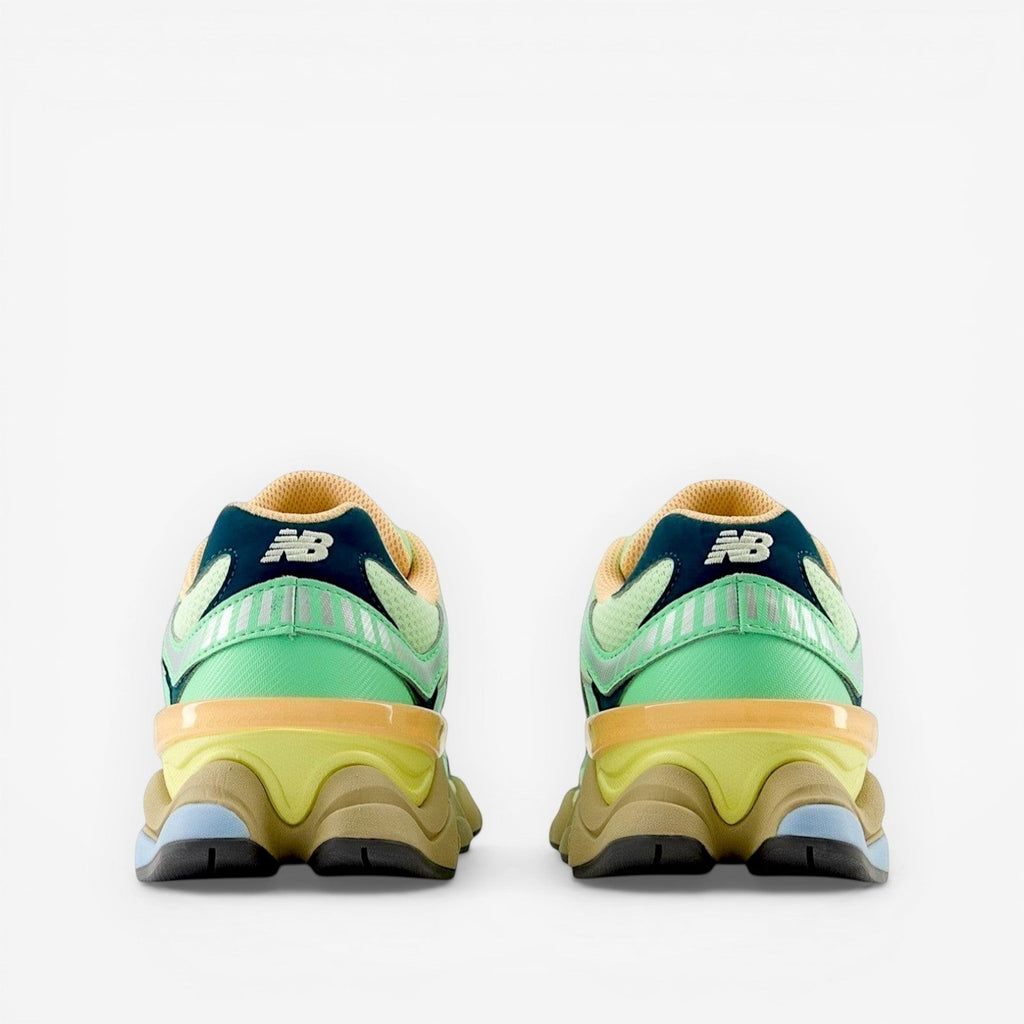 Rear view of New Balance sneakers in green, yellow, navy and tan, modern athletic footwear