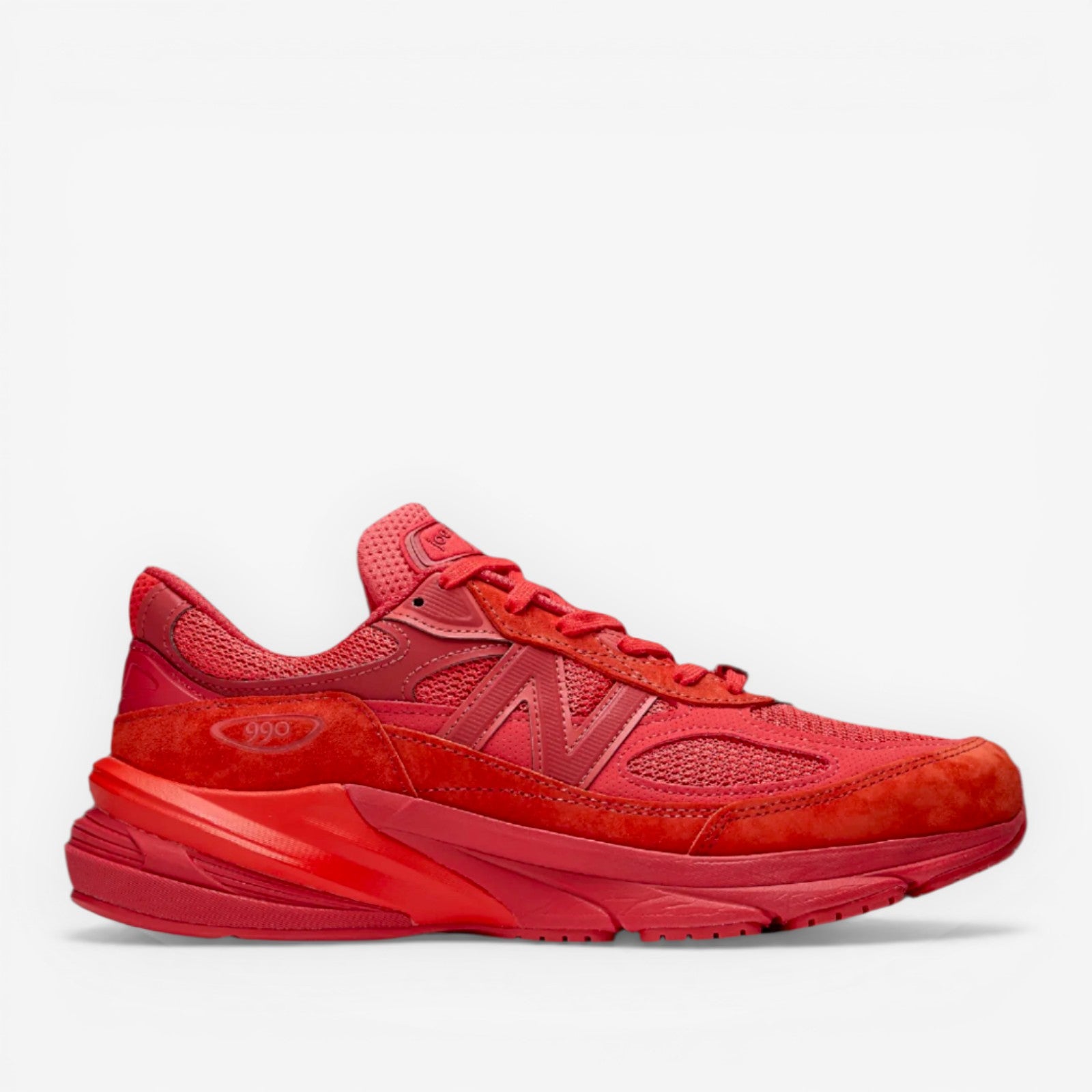 Red New Balance sneaker with mesh and suede panels, athletic footwear for men