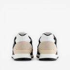 rear view of New Balance sneakers with beige suede and black leather accents, footwear