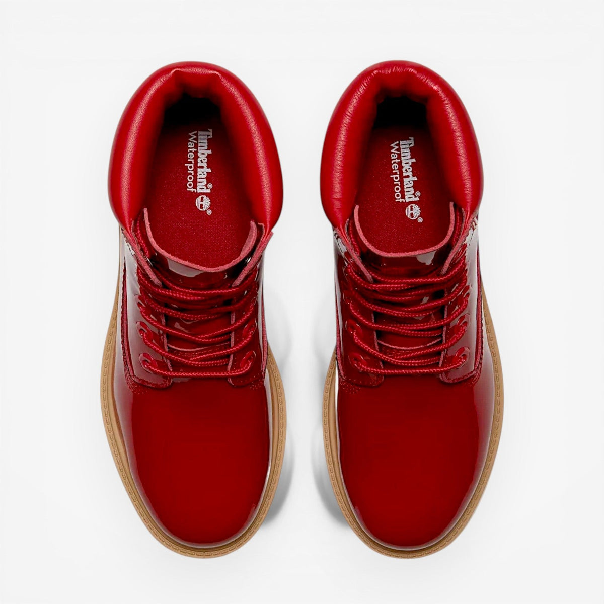 Red leather shoes with brown soles on a white background