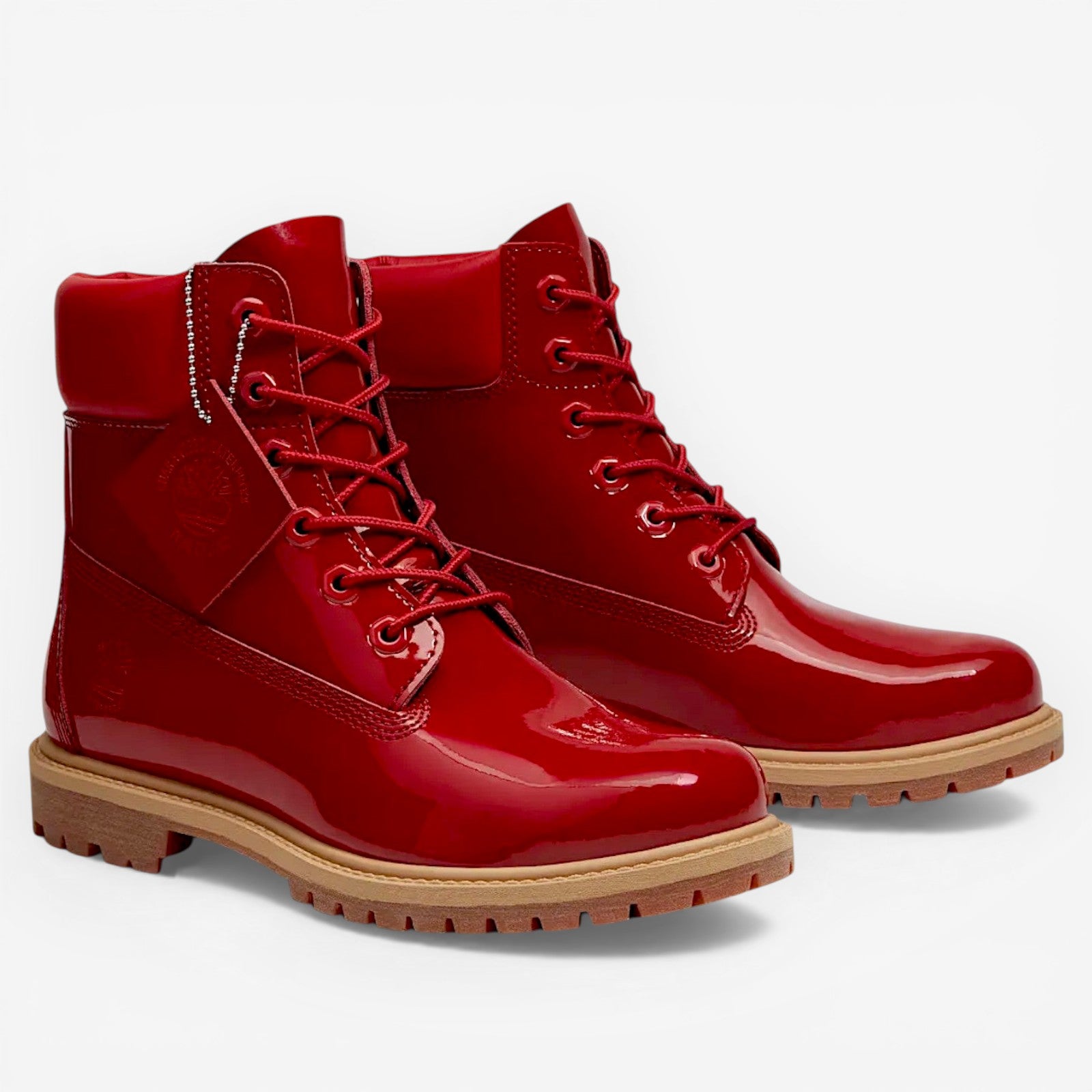 METRO Women’s Timberland red patent leather waterproof 6-inch boots with lace-up closure and lug sole.