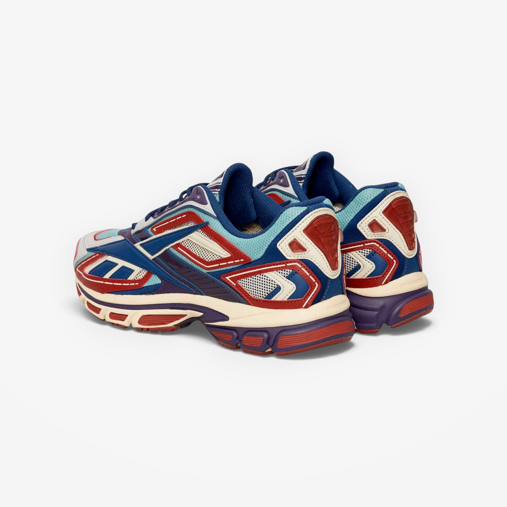 Metro Reebok Premier Road Ultra sneakers in red, hazy teal, and white with a layered design and cushioned midsole.