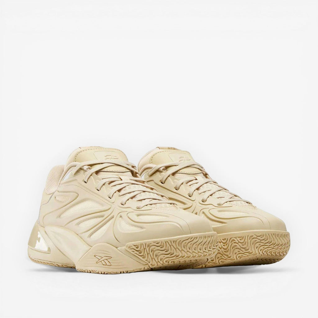 Tan Reebok sneakers with textured sole and modern layered detailing, premium footwear