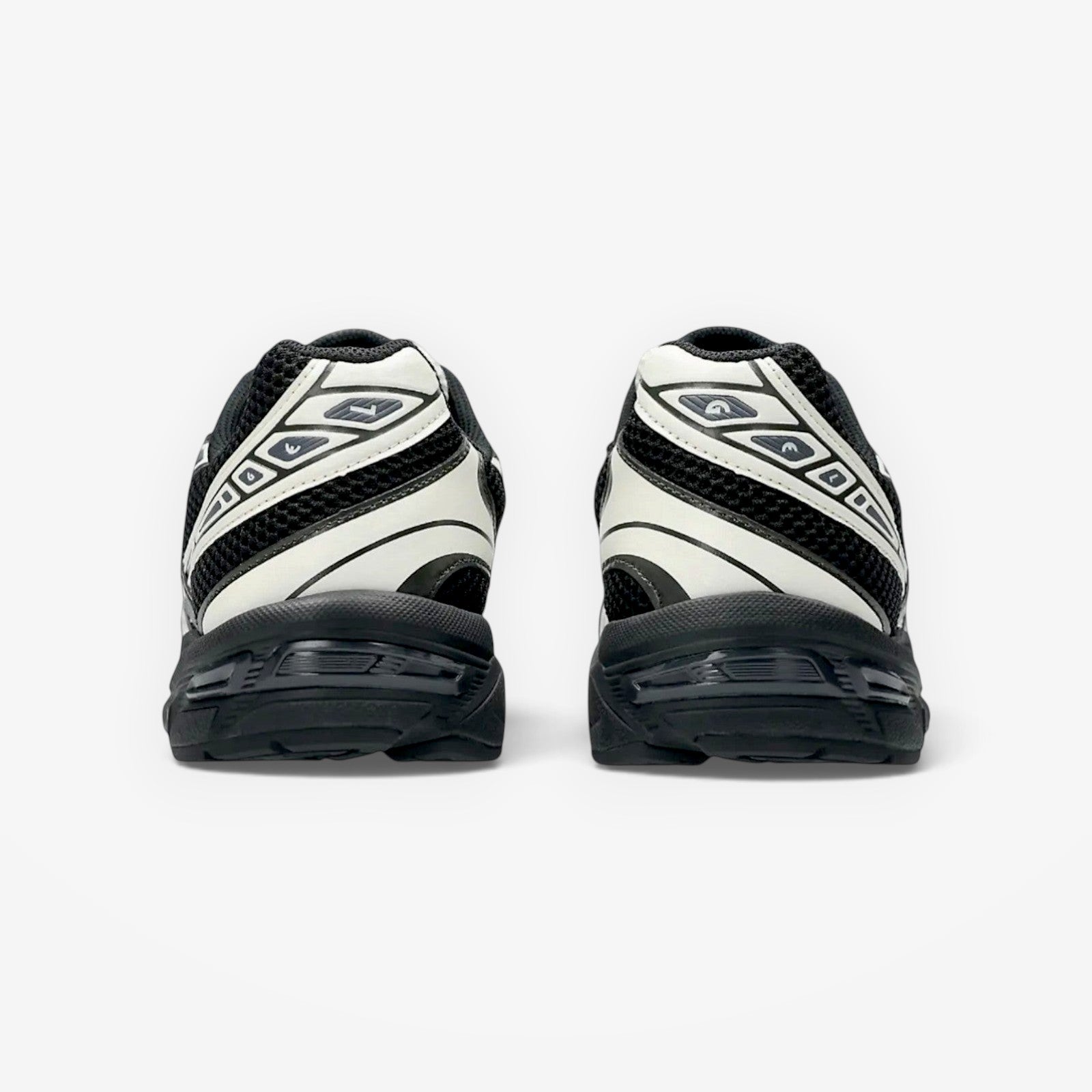 METRO ASICS GEL-1130 sneakers in black and cream, showing the rear view of the heel cushioning and stability design.