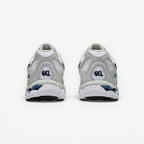 Rear view of METRO ASICS GEL-NYC sneakers in white and midnight blue with mesh, suede, and GEL cushioning technology.