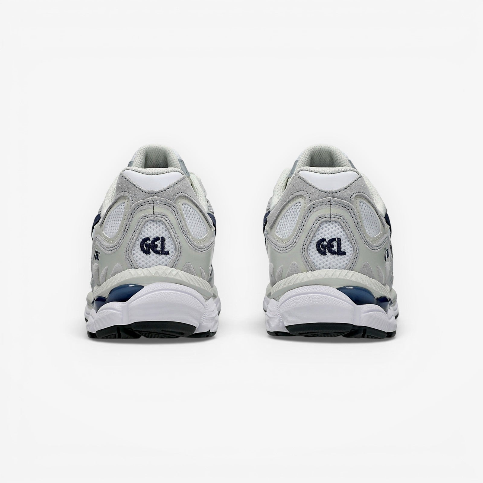 Rear view of METRO ASICS GEL-NYC sneakers in white and midnight blue with mesh, suede, and GEL cushioning technology.