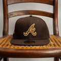METRO Atlanta Braves 1999 World Series fitted hat in brown with gold embroidered 'A' logo and side patch.