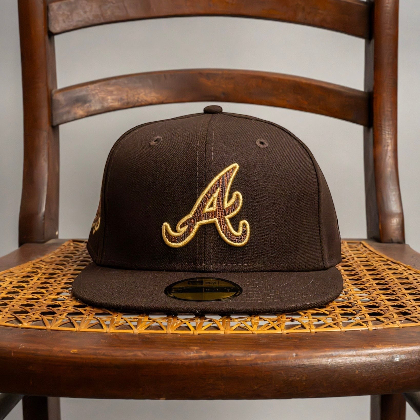 METRO Atlanta Braves 1999 World Series fitted hat in brown with gold embroidered 'A' logo and side patch.