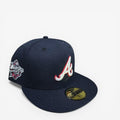 METRO Atlanta Braves navy blue fitted hat with red and white 'A' logo and metallic World Series side patch. Red underbrim.