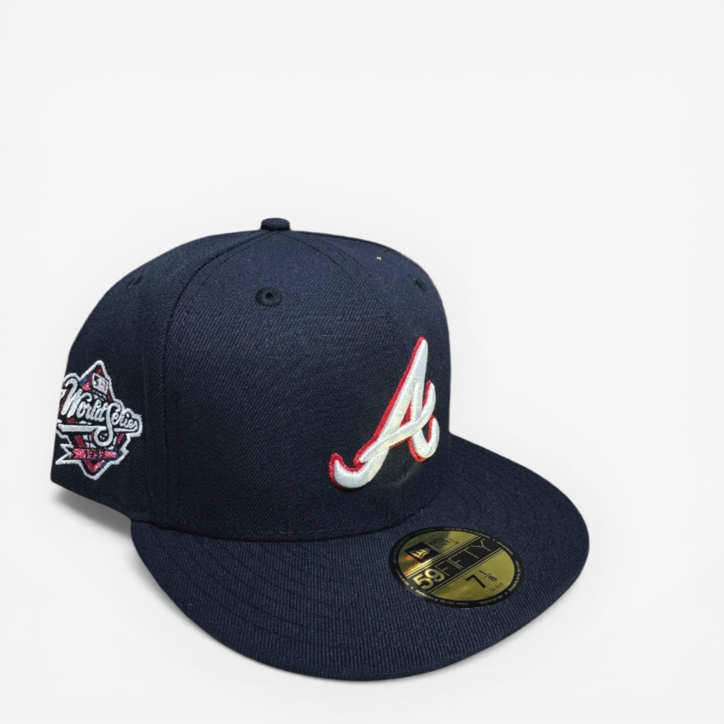 METRO Atlanta Braves navy blue fitted hat with red and white 'A' logo and metallic World Series side patch. Red underbrim.