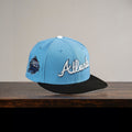 METRO Atlanta Braves blue fitted hat with white 'Atlanta' embroidery and grey UV underbrim. Features collaboration patch.