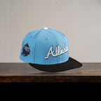 METRO Atlanta Braves blue fitted hat with white 'Atlanta' embroidery and grey UV underbrim. Features collaboration patch.