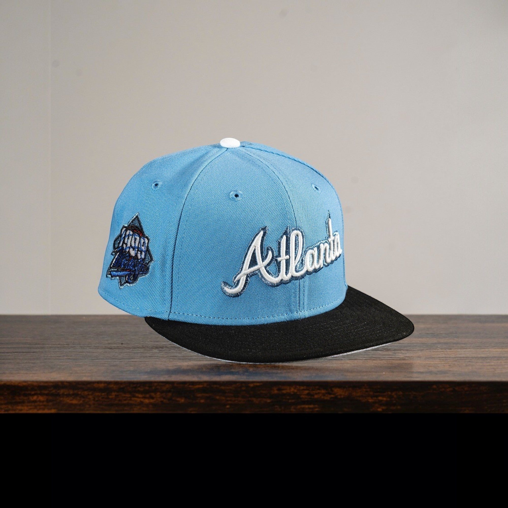 METRO Atlanta Braves blue fitted hat with white 'Atlanta' embroidery and grey UV underbrim. Features collaboration patch.