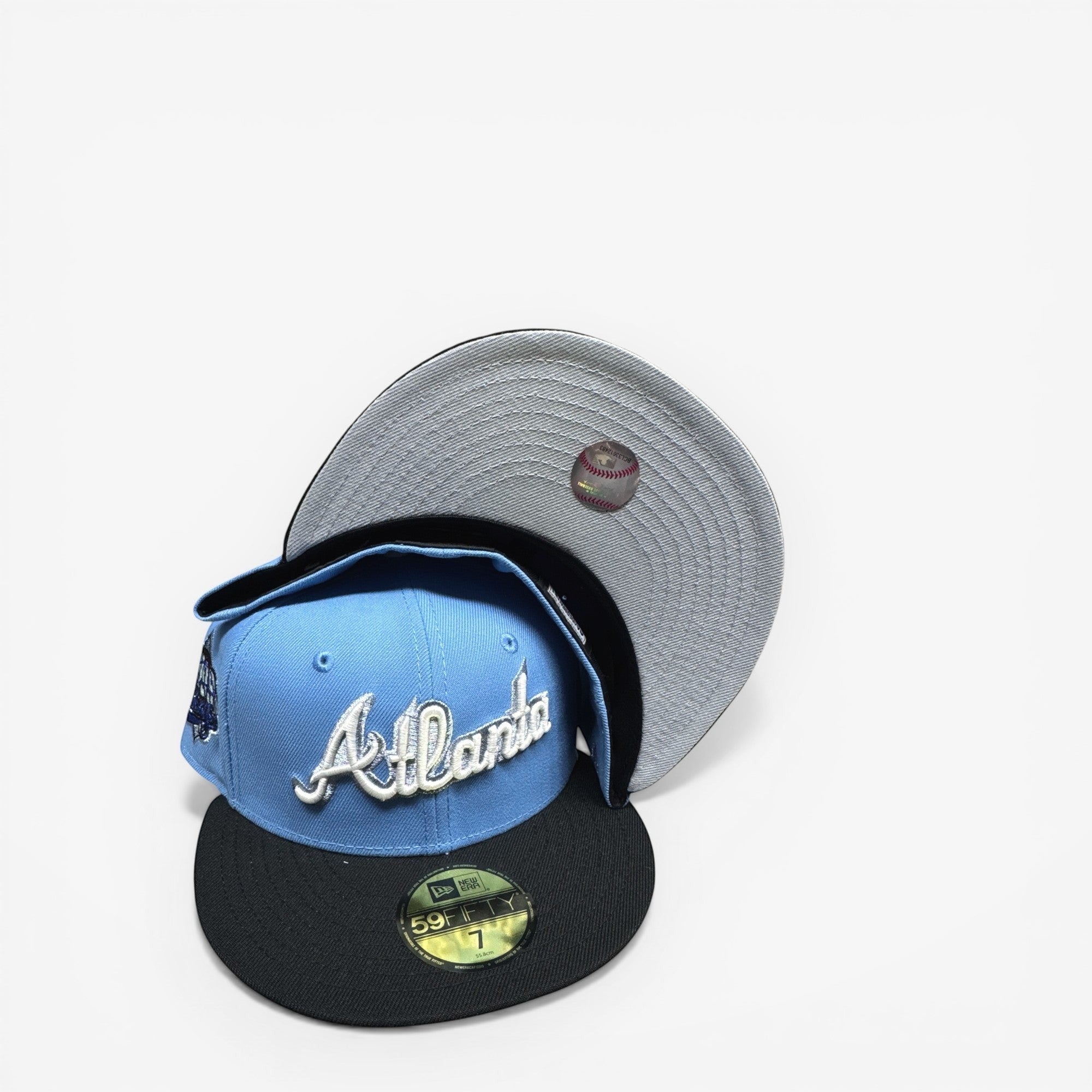 METRO Atlanta Braves blue fitted hat with white Atlanta script and grey UV underbrim. New Era 59FIFTY silhouette.