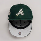 METRO Atlanta Braves green fitted hat with grey UV underbrim and Okefenokee side patch. New Era 59FIFTY silhouette.