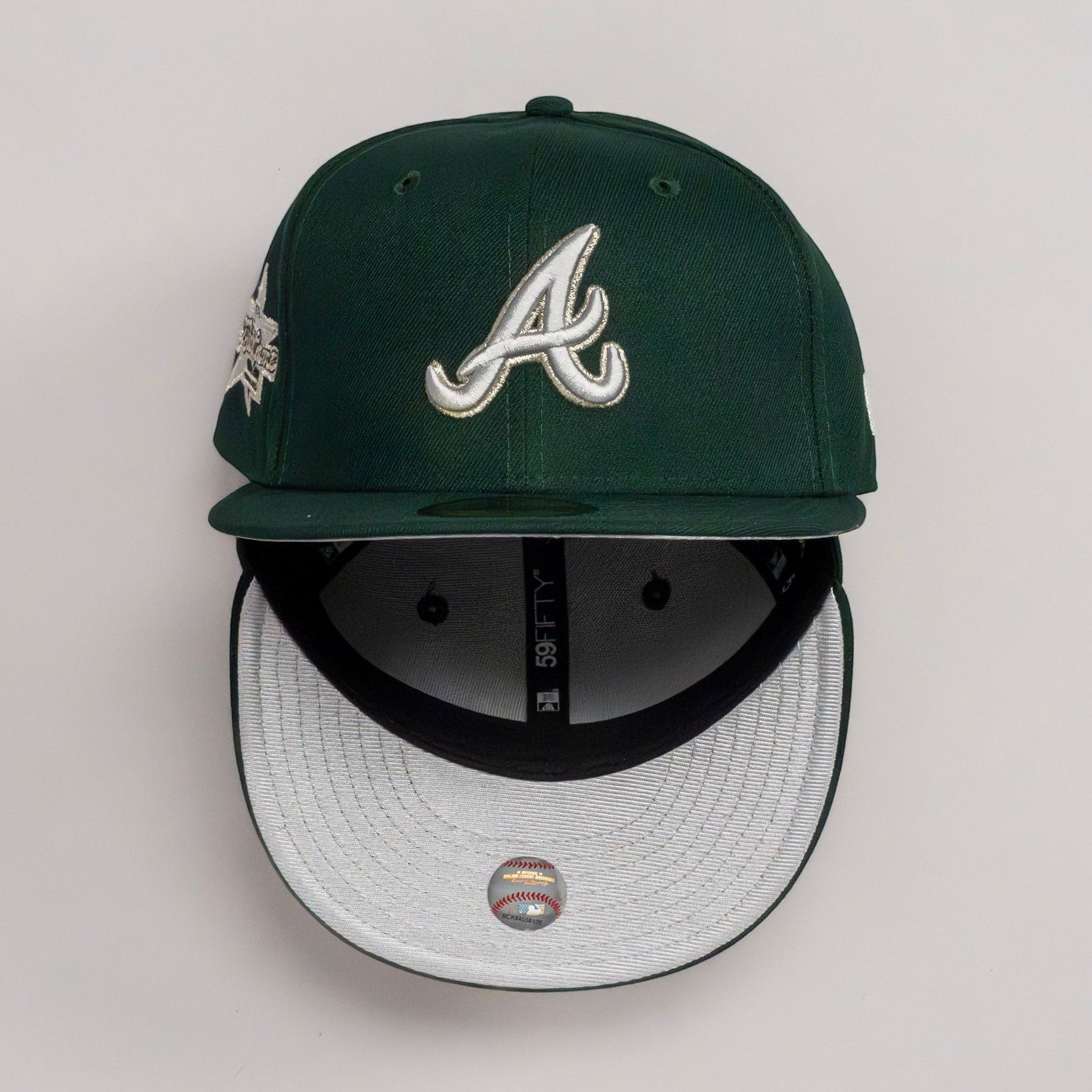 METRO Atlanta Braves green fitted hat with grey UV underbrim and Okefenokee side patch. New Era 59FIFTY silhouette.